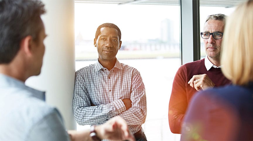 Man smiling as the thinks about the value of belonging in the workplace