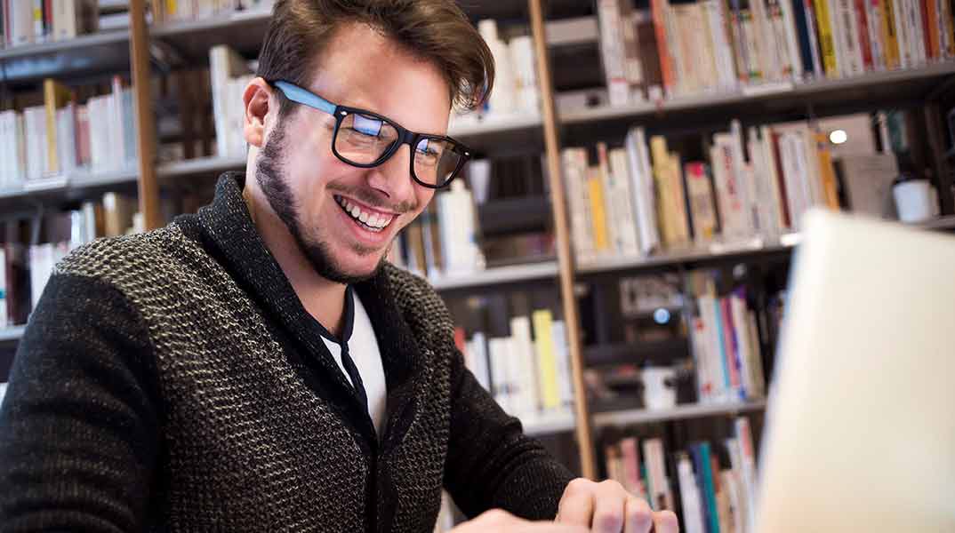 new manager smiling as he overcomes common challenges of first-time new managers