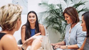 Photo of a group of people talking with leader trying to foster an innovative mindset by considering how to respond to a new idea