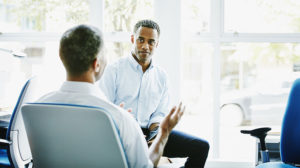 Manager giving effective feedback to another employee and discussing the different types of feedback